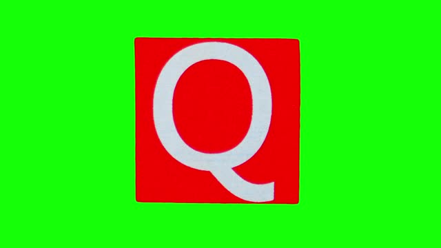 Capital letter Q on red unwrapping sticker filmed in stop motion against chroma key background