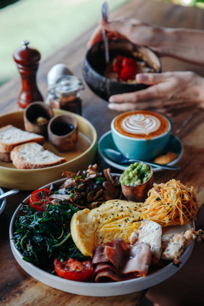 istock Morning breakfast on a table, waffles with cream, berries, coffee, cappuccino, bowl, omlet with vegetables, bread with butter, avocado cream, vegan food, healthy food, meal 1783642868