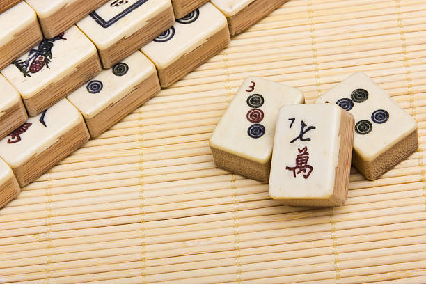 Old chinese game mahjongg on bamboo mat background