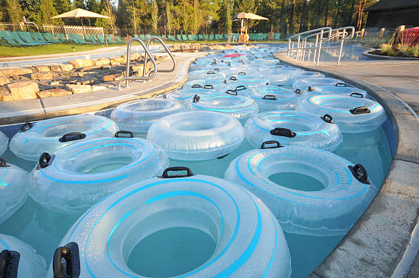 Many inner tubes floating in pool at water park stock photo
