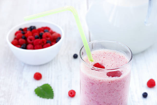 istock Raspberry and blueberry milkshake on white wooden table 178364753