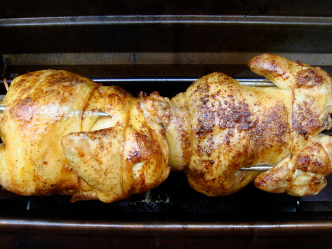 Chicken grilling on a rotisserie