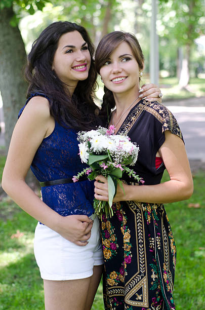 istock two beautiful girlfriends in the park 178365052