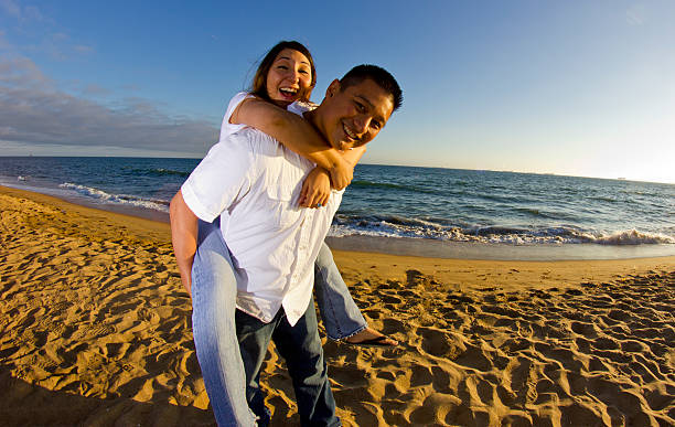 istock Asian Couple Having Fun on a Beach During a Sunset 178365059