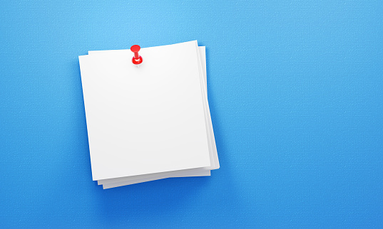 Post its notes pinned by a red thumbtack on blue background. Horizontal composition with copy space. Reminder concept.