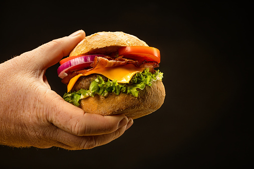 A male hand grabbing a Beefburger