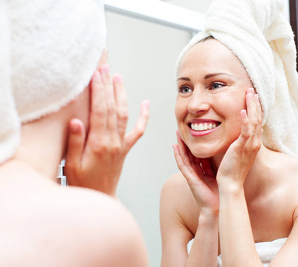 istock smiley woman looking in mirror 178366144