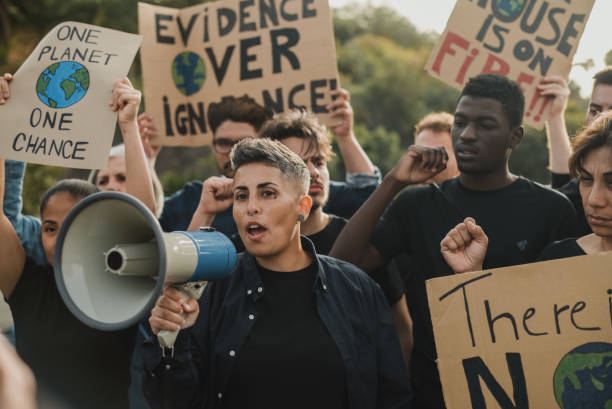 istock Determined diverse eco activists with carton placards and loudspeaker during demonstration on street 1783662616