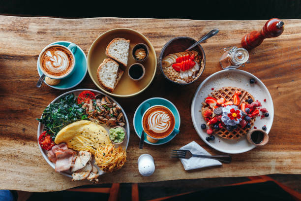 istock Morning breakfast on a table above, waffles with cream, berries, coffee, cappuccino, bowl, omlet with vegetables, bread with butter, avocado cream, vegan food, healthy food, meal 1783663834