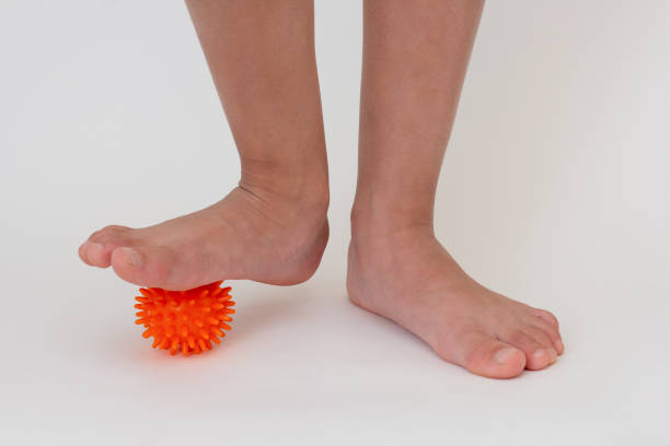 istock Cropped child legs doing exercises with spiky needle ball 1783665759