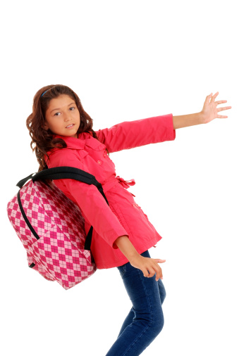 isolated School girl struggling heavy backpack