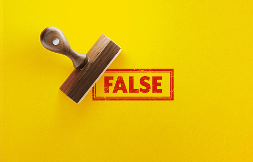 False stamp on yellow background. Horizontal composition.