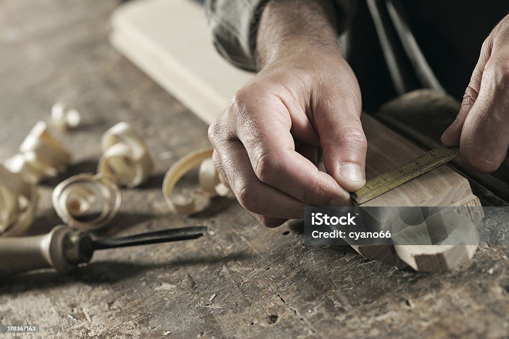hands of a craftsman Carpenter Measuring a Wooden Plank Accuracy Stock Photo