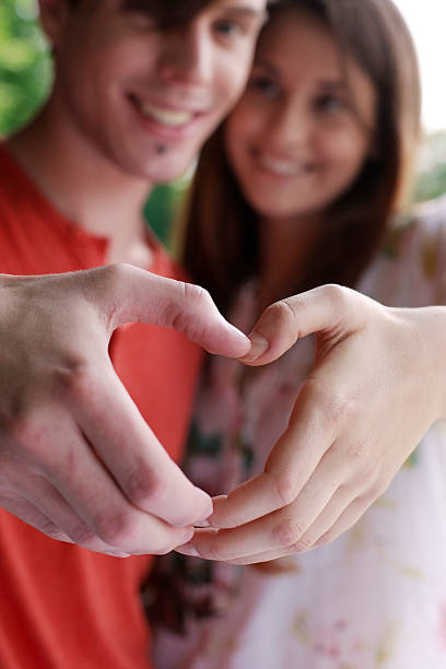 istock Couple making a heart symbol with their hands 178367568