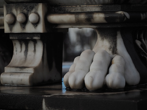 A marble foot with claws in a cementery