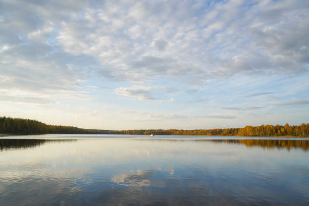 Lake reflecting sky in autumn landscape