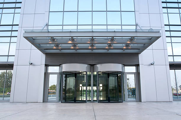 The main entrance of a modern business building Modern busineness building main entrance bank entrance stock pictures, royalty-free photos & images