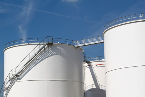 White storage tanks at an oil refinery.