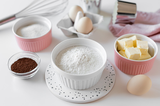 food ingredients for baking and kitchen utensils on kitchen table