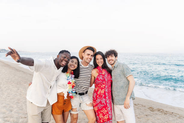istock Happy multi ethnic friends hanging out having fun outdoors on the beach 1783684563