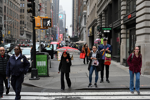 New York, New York, USA, April 5, 2023 - Pedestrian traffic light at the intersection of 7th Ave and 36th Street downtown Manhattan, New York City, USA.