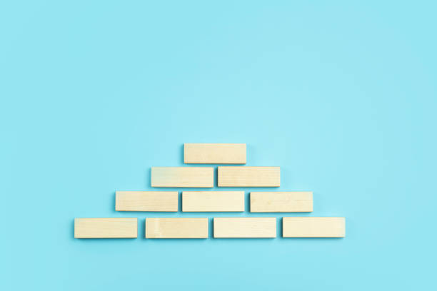 istock Business growth, development plan concept and business analytics background. Wooden steps of blocks on a blue background as financial and career growth, increase in monetary income and economic development. 1783686181