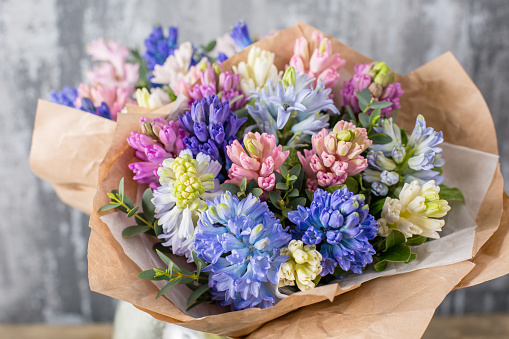 Small Beautiful bouquet of mixed flowers in woman hand. Floral shop concept . Beautiful fresh cut bouquet. Flowers delivery