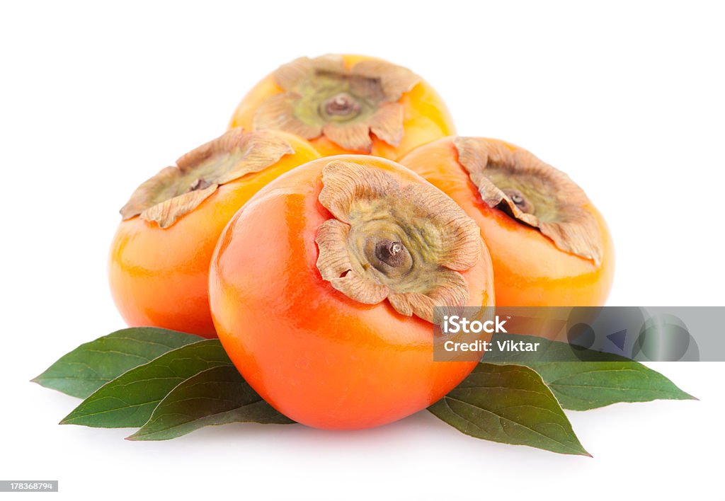 ripe persimmons ripe persimmons with leaves isolated on white background Cut Out Stock Photo