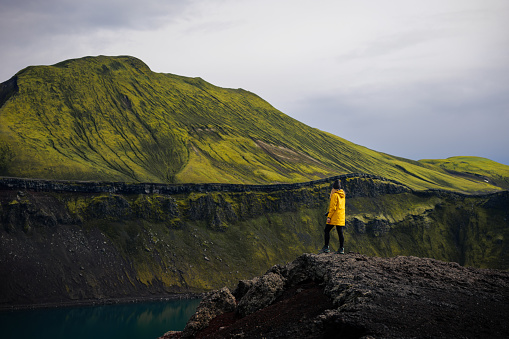 Backpacker girl takes in the view of Blahylur lake in Iceland