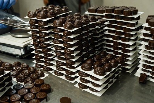 Chocolates in box, various luxury pralines. Chocolate candy making.