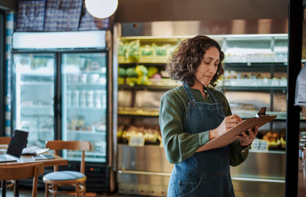 istock Mature deli owner taking inventory in her store using a clipboard 1783702158