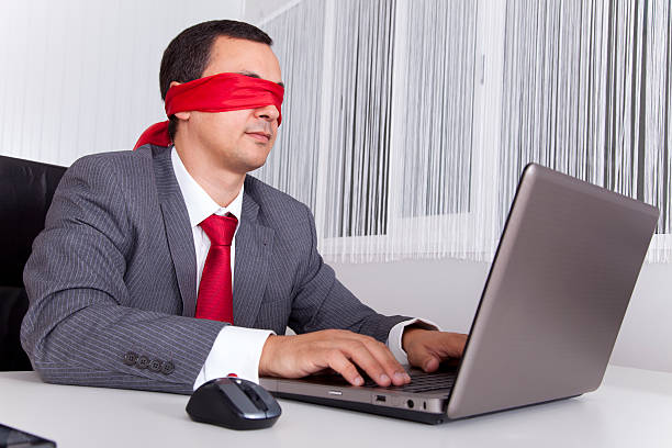istock Blindfold businessman working with his laptop 178370278