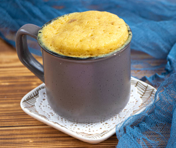 istock vanilla mugcake is microwaved. Homemade cupcake in a coffee mug. 1783704582