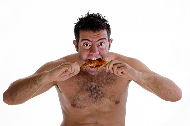 Wild bite Wild man eating chicken leg. hairy fat man pictures stock pictures, royalty-free photos & images