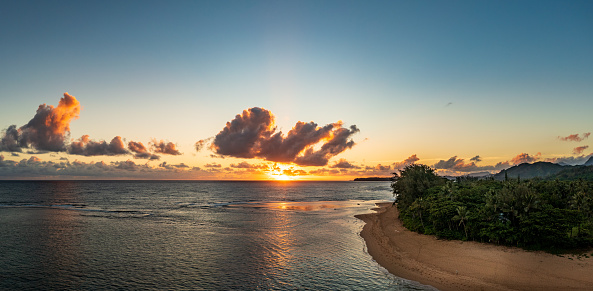 Aerial panorama of sunrise over Tunnels Beach Kauai Hawaii