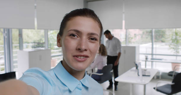 istock Cheerful caucasian young woman looking at camera making video call using mobile phone 1783710298