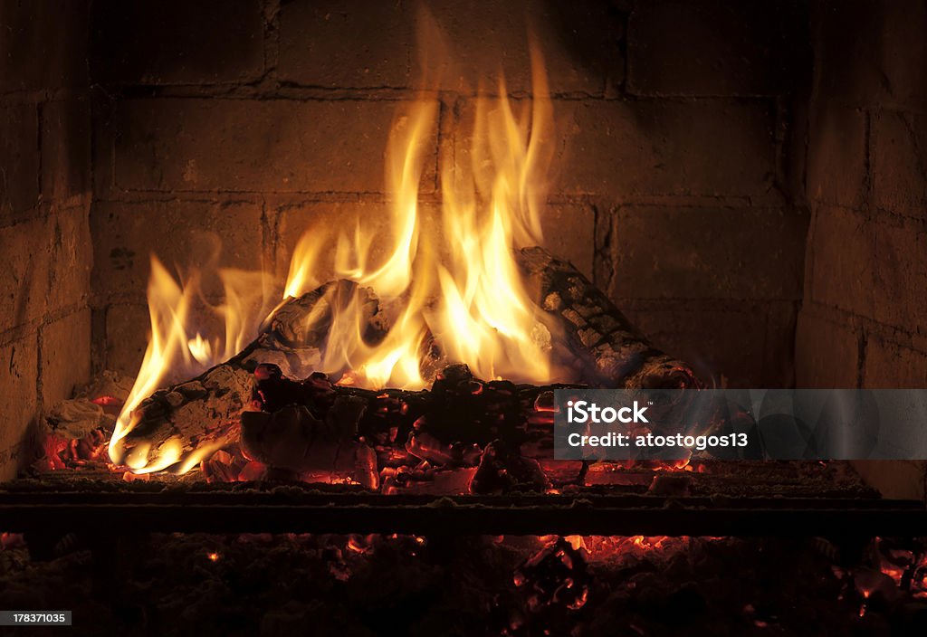 yellow flames in the darkness yellow flames in the fareplace Architectural Feature Stock Photo