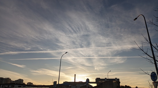 Sunset sky and airplane footprints in the industrial sector of Amadora Lisbon