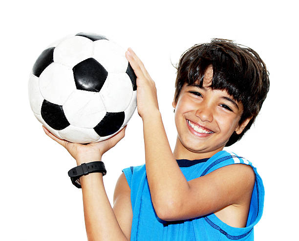Cute boy playing football stock photo