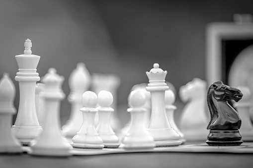 A closeup of a chess figures on a chessboard