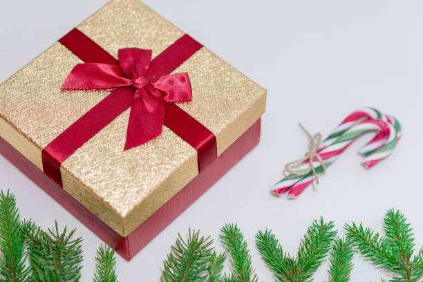 istock Christmas gifts box, branches and candy canes against a white background 1783716961