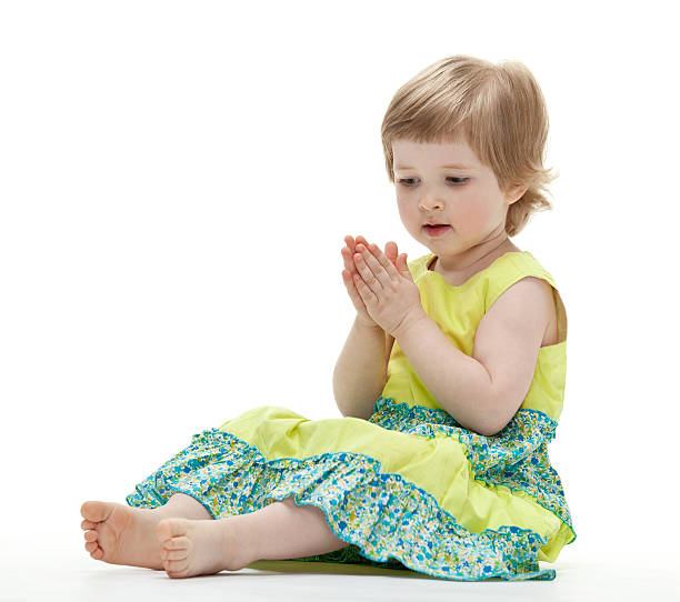 Baby playing sitting on the floor on white background