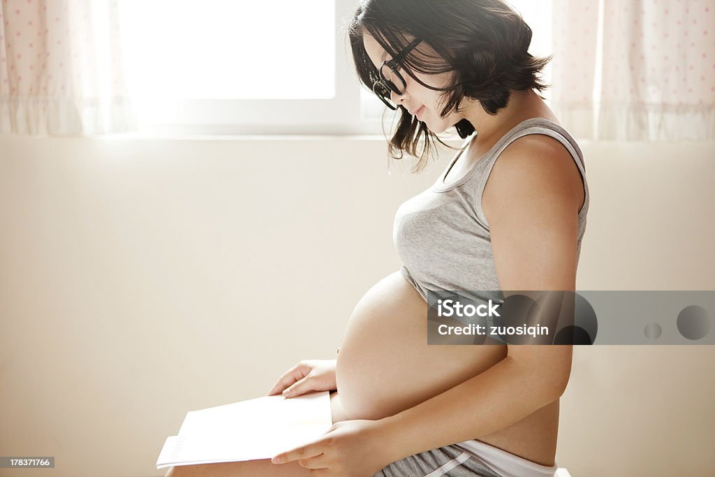 Pregnant woman A pregnant women read a Book Pregnant Stock Photo