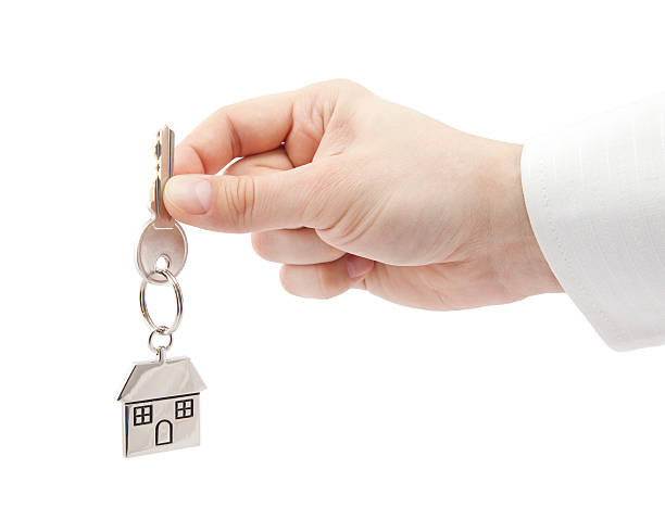 House key in hand with clipping path stock photo