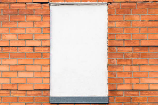 istock carrot color old brick wall - empty white poster, copy space. 1783722491