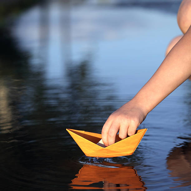 istock paper ship in children hand 178372648