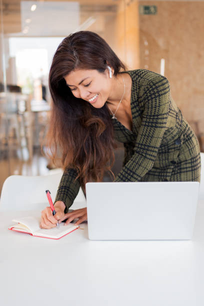 istock Happy woman with organizer and laptop 1783727856