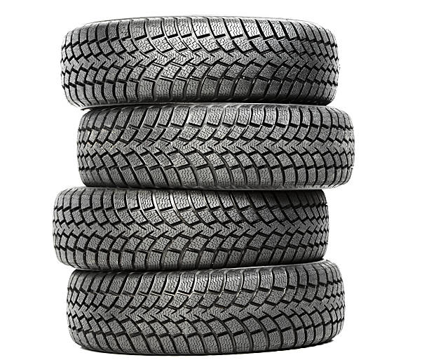 Stack of four car wheel winter tires isolated stock photo
