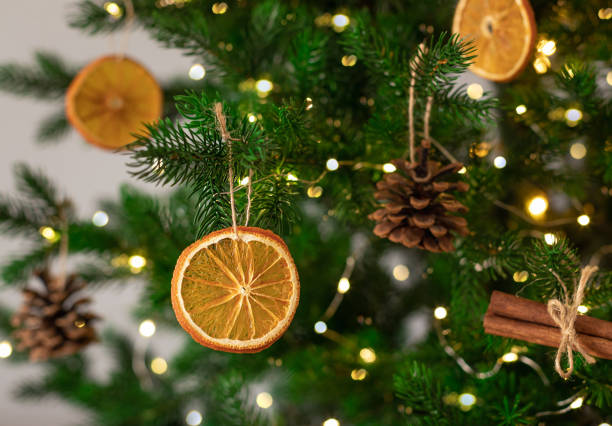 istock Decorated Christmas tree closeup. DIY dried oranges, cones and cinnamon 1783729469