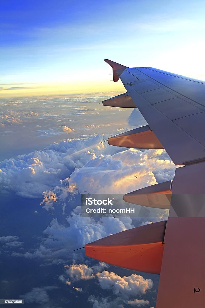 View of jet plane View of jet plane wing with cloud patterns Aerospace Industry Stock Photo